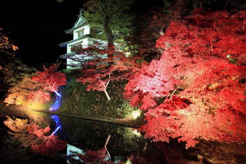 a house in the middle of a forest of trees at プレジール弘前101 in Hirosaki
