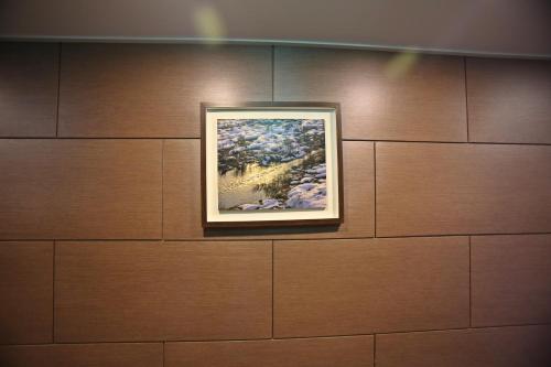 a painting hanging on a wall in a museum at Champion Hotel in Jeju