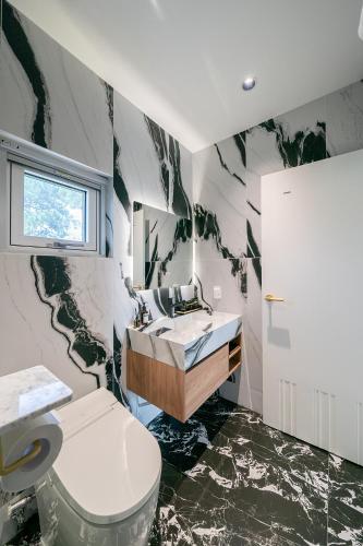 a bathroom with a sink and a toilet at Eudaimonia Poolvilla Jeju 에다모니아 함덕풀빌라 in Jeju