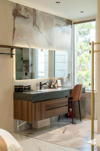 a bathroom with a sink and a large mirror at Eudaimonia Poolvilla Jeju 에다모니아 함덕풀빌라 in Jeju