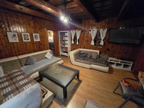 a living room with two couches and a tv at Chalupa Liptovský dych in Svätý Kríž