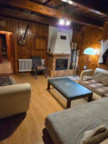 a living room with a couch and a fireplace at Chalupa Liptovský dych in Svätý Kríž
