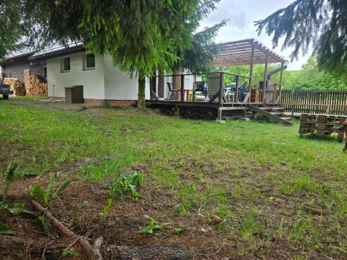 a house with a playground in the yard at Chalupa Liptovský dych in Svätý Kríž