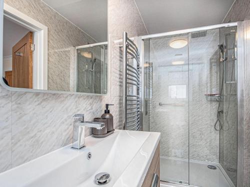 a bathroom with a sink and a shower at Terra Verde in Beauly