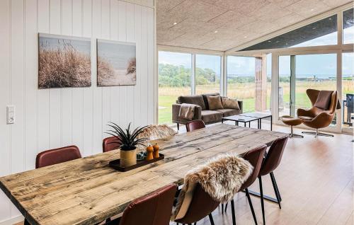a living room with a wooden table and chairs at Lovely Home In Haderslev With Sauna in Haderslev