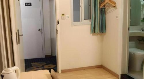 a bathroom with a toilet and a sink at 7 Days Inn Qingdao Liaoyang West Road Xinye Plaza Metro Station in Qingdao