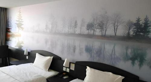 a bedroom with a large painting on the wall at 7 Days Inn Qingdao Liaoyang West Road Xinye Plaza Metro Station in Qingdao