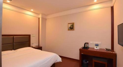 a hotel room with a bed and a television at GreenTree Inn Hefei Huangshan Road Daxidi 1912 Express Hotel in Hefei