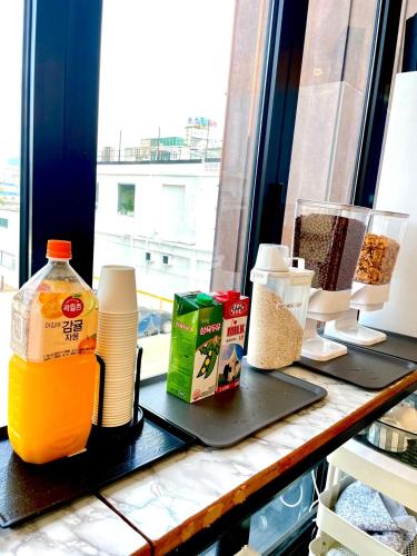 a counter with food and a bottle of orange juice at Gyeongju BonghwangMansion in Gyeongju