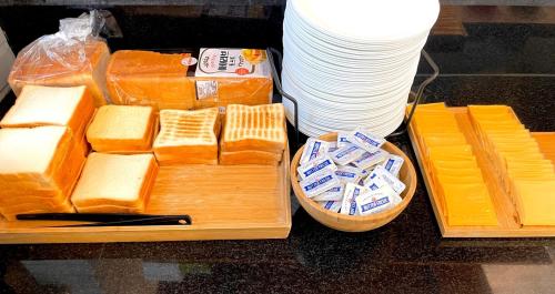 a tray of cheese on a table with a bunch of plates at Gyeongju BonghwangMansion in Gyeongju