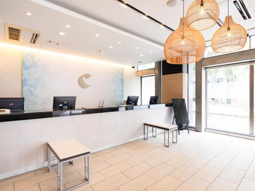a waiting room with a counter and chairs at Comfort Hotel Naha Prefectural Office in Naha