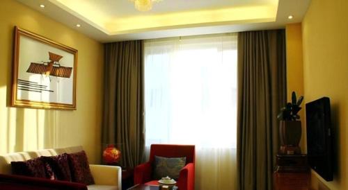 a living room with a couch and a window at Xiamen Airlines Quanzhou Hotel in Quanzhou