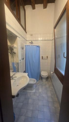a bathroom with a sink and a toilet and a shower at Ca' Amore Venezia in Venice