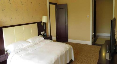 Ένα ή περισσότερα κρεβάτια σε δωμάτιο στο Inzone Garland Hotel Taian