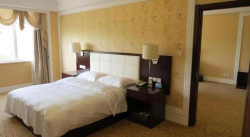 Ένα ή περισσότερα κρεβάτια σε δωμάτιο στο Inzone Garland Hotel Taian