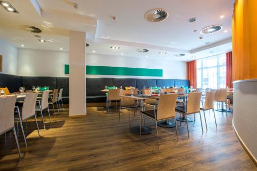 a dining room with tables and chairs at Park Inn by Radisson Nürnberg in Nuremberg