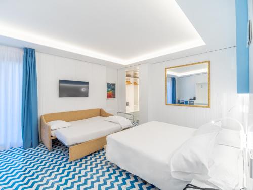 En eller flere senge i et værelse på Hotel Cristina