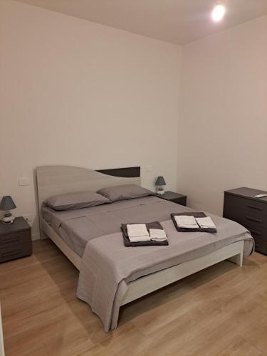 a bedroom with a bed with two towels on it at San Francesco Home in Terni