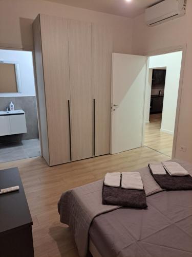 a bedroom with a bed with two towels on it at San Francesco Home in Terni