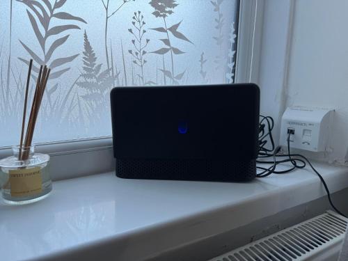 a laptop computer sitting on a window sill at Brits-Halley Luxury Apartments in Annfield Plain