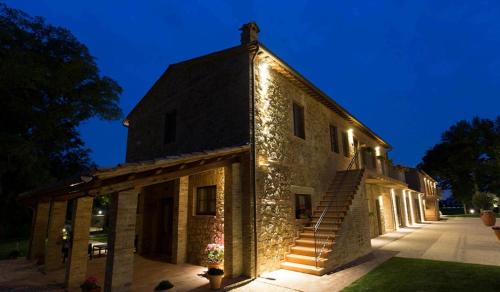 a stone building with lights on the side of it at Casale San Galgano in Chiusdino