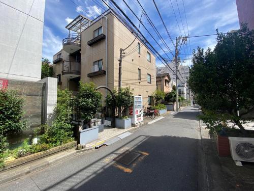 an empty street in a city with a building at Ema eve HOUSE in Tokyo