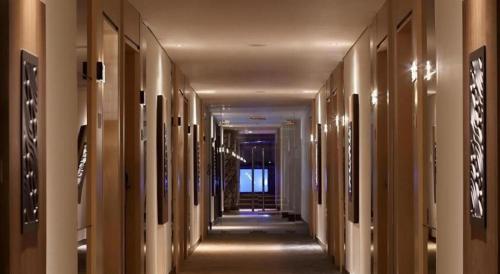a hallway of a building with wooden columns at Hotel Grandhika Pemuda in Semarang