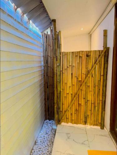 a room with a wooden wall next to a door at The bora bora - Bed and Dream เดอะ โบรา โบร่า - เบด แอนด์ ดรีม in Ban Chek