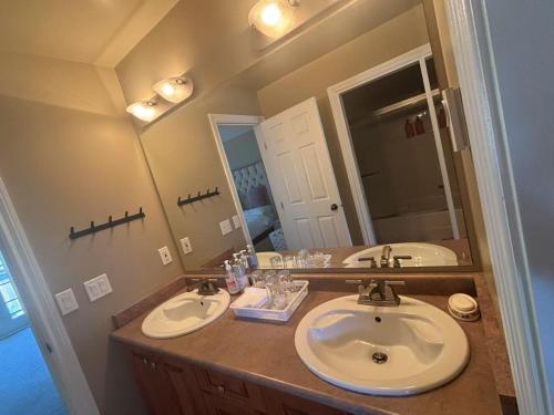 a bathroom with two sinks and a large mirror at Rosehouse 2Bedrooms sleep 4 2nd floor private bathroom in Coquitlam