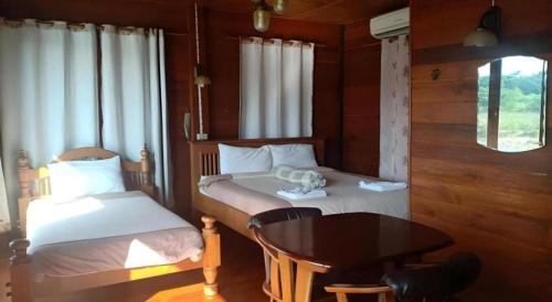 Postel nebo postele na pokoji v ubytování P&P Coffee & Resort Maesariang