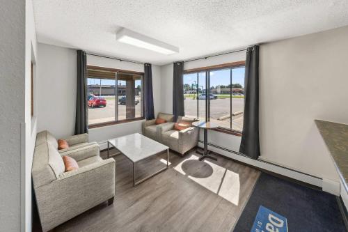 a living room with two couches and a table at Days Inn by Wyndham Winona in Winona