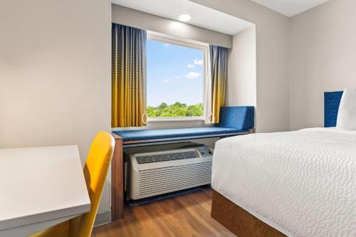 a room with a bed and a window at Microtel Inn and Suites - Salisbury in Salisbury