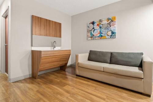 a living room with a couch and a sink at Microtel Inn and Suites - Salisbury in Salisbury