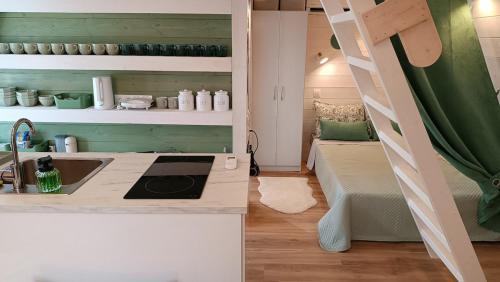 a kitchen with a sink and a ladder in a room at White DIAMOND in Chalkidiki in Vergia