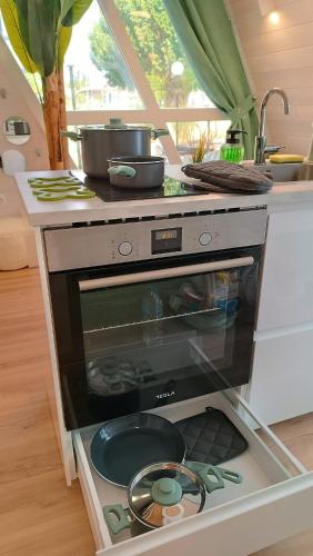 a kitchen with a stove with a pot on top at White DIAMOND in Chalkidiki in Vergia