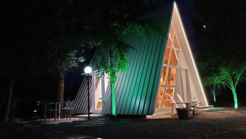 a building with a light on the side of it at night at White DIAMOND in Chalkidiki in Vergia