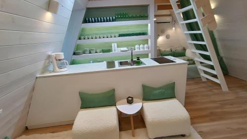 a kitchen with a counter with two chairs and a sink at White DIAMOND in Chalkidiki in Vergia
