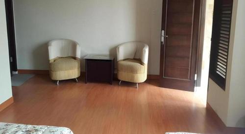 two chairs and a table in a living room at Fafa Hill Hotel and Resort in Bogor