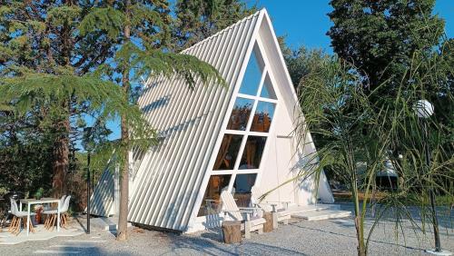 a small white house with a large window at White DIAMOND in Chalkidiki in Vergia
