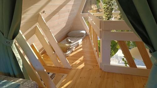 an attic room with a staircase leading to an open window at White DIAMOND in Chalkidiki in Vergia