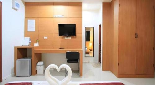 a room with a desk with a heart sculpture in it at Phakawan Hotel in Maha Sarakham