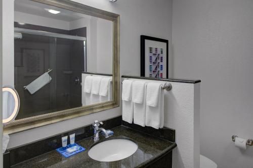 a bathroom with a sink and a mirror at Hyatt House Fishkill-Poughkeepsie in Fishkill