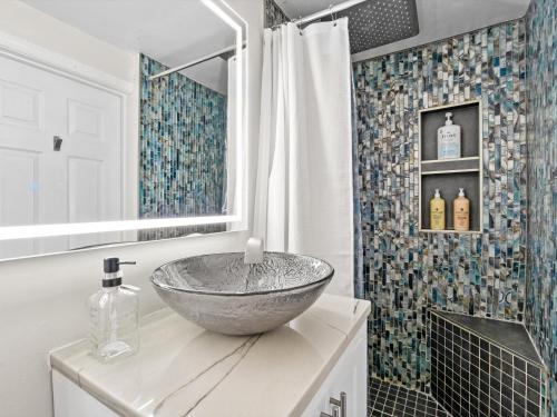 a bathroom with a bowl sink on top of a counter at Contemporary Lux Pad Patio in Alexandria