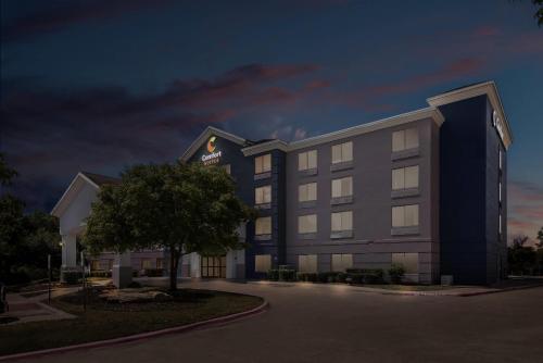 a rendering of a hotel at night at Comfort Suites Austin Airport in Austin