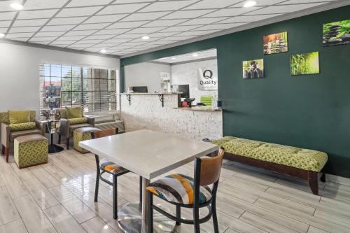 a waiting room with a table and chairs and a counter at Quality Inn Forrest City I-40 in Forrest City
