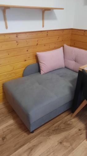 a bed with two pillows on it in a room at Penzion a drevenica pri Hati in Terchová