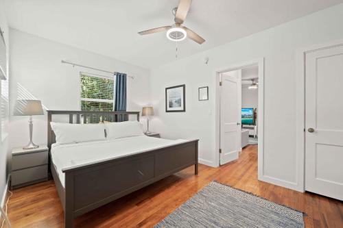 a bedroom with a bed and a ceiling fan at Condo by the Beach King Bed Lush Patio w BBQ Breakers Key Three H0MES in Fort Lauderdale