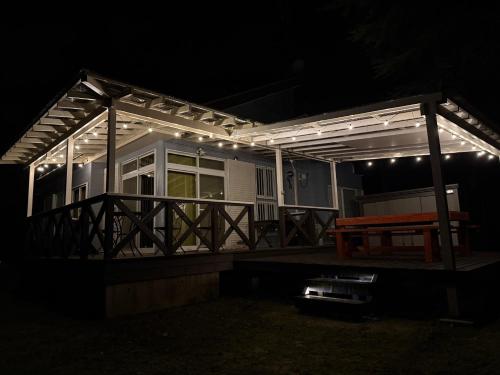 a house with a deck lit up at night at コテージ33 in Nasu