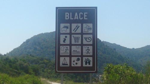 a sign on the side of a road at Apartments Laura in Blace