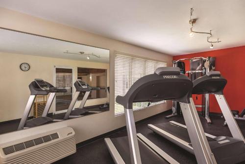 a fitness room with tread machines and a mirror at Country Inn & Suites by Radisson, Madison, WI in Madison